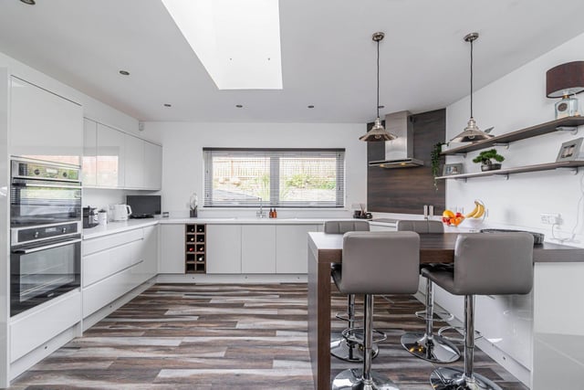The fully-fitted stylish modern kitchen with breakfast bar and a skylight providing excellent natural light.