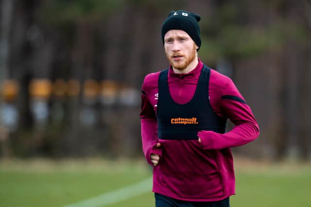 Hearts striker Liam Boyce is determined to play through back pain to help the club.