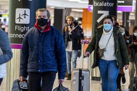 Passengers travel through Edinburgh Airport wearing face masks. Picture: Lisa Ferguson