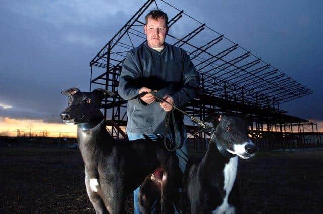 Owner Craig Dobie with hounds Autumn and Merlin at the part-built stadium
