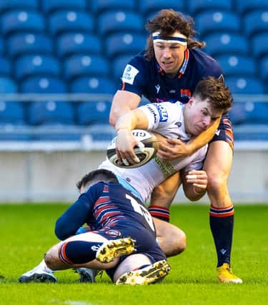 Hamish Watson, top, gets to grips with Glasgow's Huw Jones during Edinburgh's 1872 Cup win on Saturday. Picture: Ross Parker/SNS