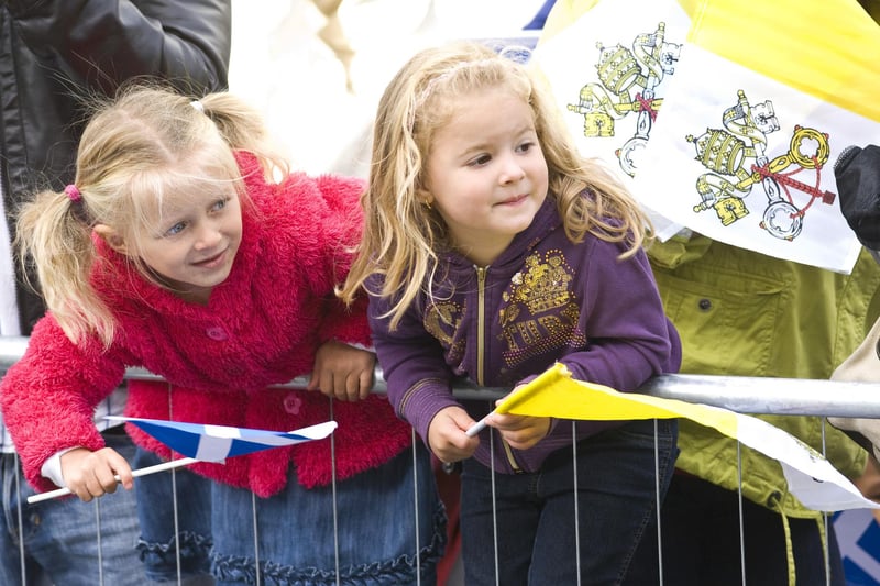 Many school children were among the crowds who turned out to see the Pope.  These two are ready with their flags - a saltire and and a Papal flag - and eagerly looking for the special visitor, keen to witness a moment of history - only the second time a Pope had visited Scotland.