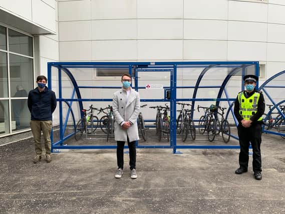 Ian Mackenzie, Edinburgh and Lothians Health Foundation, Adam Duncan-Rusk, NHS Lothian and Graeme Finlay, Police Scotland in front of the improved bike storage facilities at the Royal Infirmary of Edinburgh