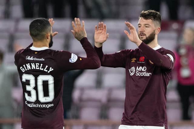 Goalscorer Josh Ginnelly and defender Craig Halkett, back on the pitch after two months out through injury, embrace at full time after Hearts fought back to draw 1-1 with Livingston. Picture:  Paul Devlin / SNS