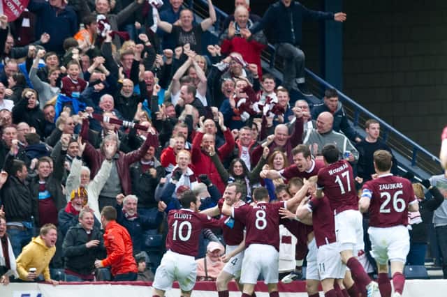 Hearts players and fans celebrate against Celtic. Picture: SNS