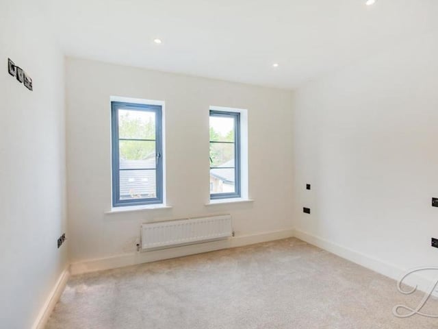 A bright and bonny bedroom, with windows to the front and a carpeted floor. Sure to be cosy.