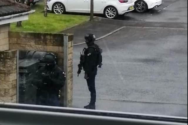 Armed officers pictured outside a property in Queens Crescent in Livingston. Picture: Steve Binnie.