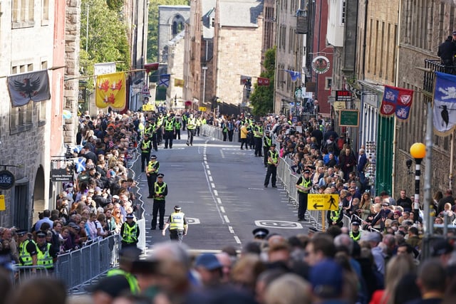 Police officers on the Royal Mile in Edinburgh ahead of the procession of Queen Elizabeth's coffin from the Palace of Holyroodhouse to St Giles' Cathedral, Edinburgh, following her death on Thursday. Picture date: Monday September 12, 2022.