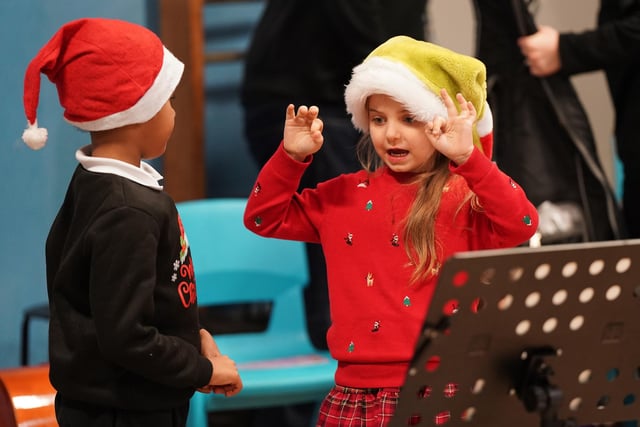 This girl shows a fellow performer how it's done at the Christmas concert in Wester Hailes.