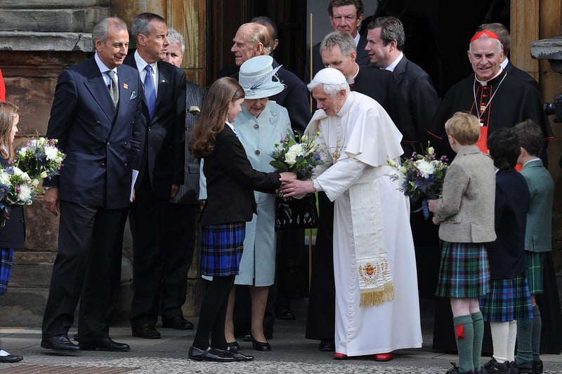 Outside the Palace of Holyroodhouse, the guard of honour, provided by the Royal Company of Archers, the Queen's bodyguard of Scotland, accompanied by the Band of the Royal Regiment of Scotland, gave a Royal Salute.  And before his departure, Pope Benedict was presented with flowers.