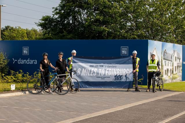Members of the Dandara team with their banner for the Tour of Britain cycle race.