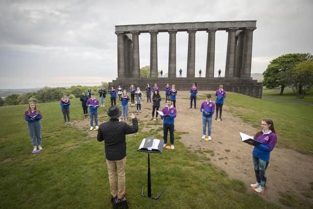 Members of the National Youth Choir of Scotland, with founder and conductor Christopher Bell, on Calton Hill at 6am on Monday. (Picture credit: Jane Barlow/PA Wire)