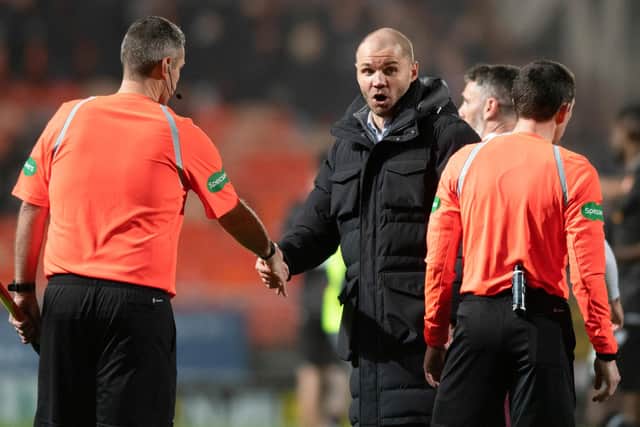 Robbie Neilson speaks with referee Colin Steven after the conclusion of Hearts' 2-2 with Dundee United at Tannadice. Picture: SNS