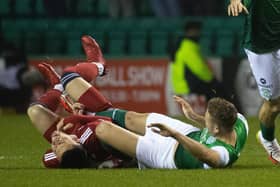 Ryan Porteous and Christian Ramirez have a coming together at the half-way line during Hibs' 1-0 win over Aberdeen. Picture: SNS