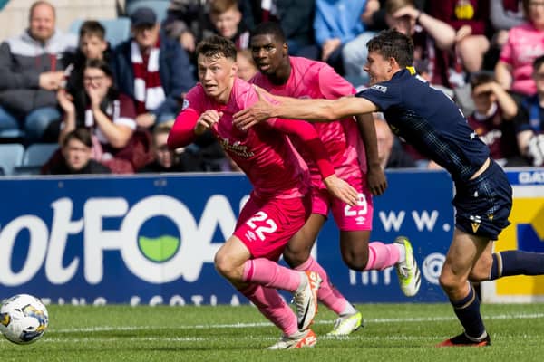 Hearts midfielder Aidan Denholm and Dundee's Owen Beck during the cinch Premiership match at Dens Park. Pic: SNS