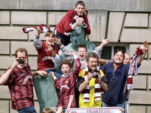 Hearts fans celebrate their team winning the Tennents Scottish Cup in 1998 by climbing on this statue on the Royal Mile to welcome their heroes back to Edinburgh.