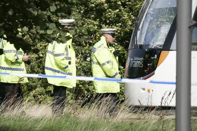 Accident investigators survey the damage caused to the tram.