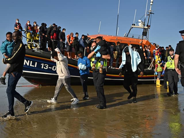 People land on a beach at Dungeness after being picked up by an RNLI lifeboat (Picture: Ben Stansall/AFP via Getty Images)