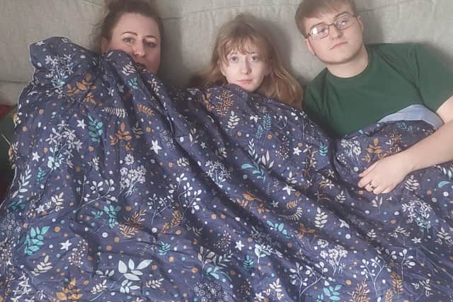 Heather and her children put on blankets to stay warm