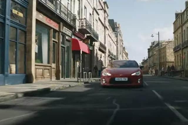 The trailer shows a car racing down what appears to be a composite incorporating Melville Street in the West End of the city before crashing through a whisky shop (Photo: Universal Pictures).
