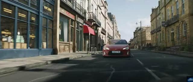 The trailer shows a car racing down what appears to be a composite incorporating Melville Street in the West End of the city before crashing through a whisky shop (Photo: Universal Pictures).