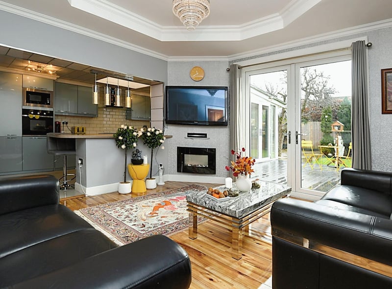 The spacious living room features a living flame gas fire and French doors leading out to the garden.