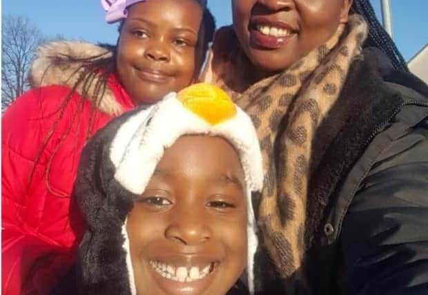 Nursing student Naggayi Angella with her children Annmarie Yiga, 12 and John Jeremiah Mugisha, eight.