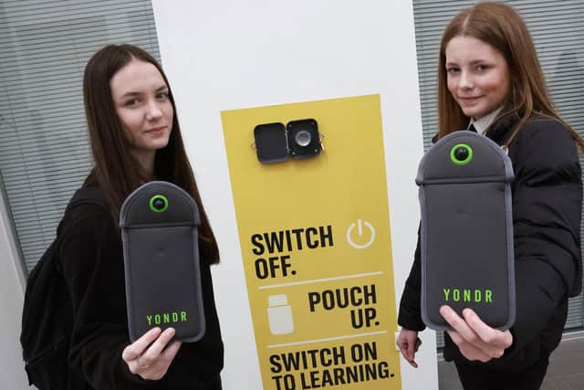 Portobello High School is piloting a scheme where pupils place their devices into locked pouches for the duration of the school day. Pictured are S3 pupils Julia and Carly. Picture: Lisa Ferguson.