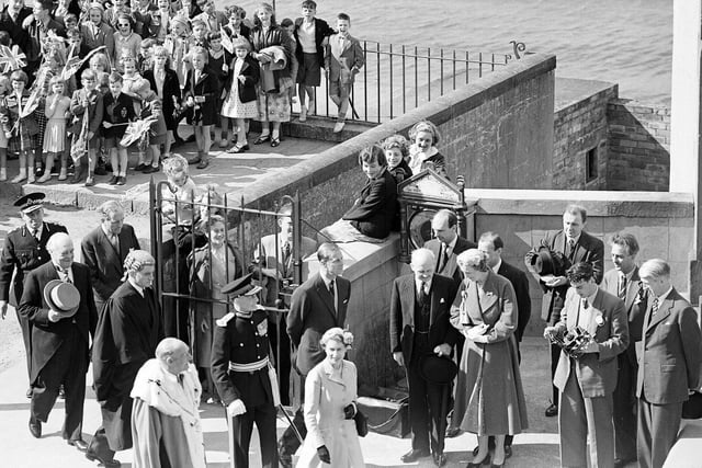 Queen Elizabeth II and the Duke of Edinburgh at South Queensferry (bottom of  photo), cheered by school children in 1955.
