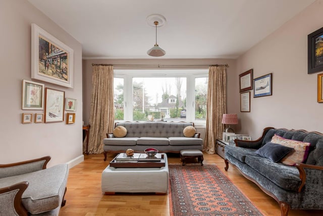 The property's bright living room with bay window, which could also be used as a fourth double bedroom.