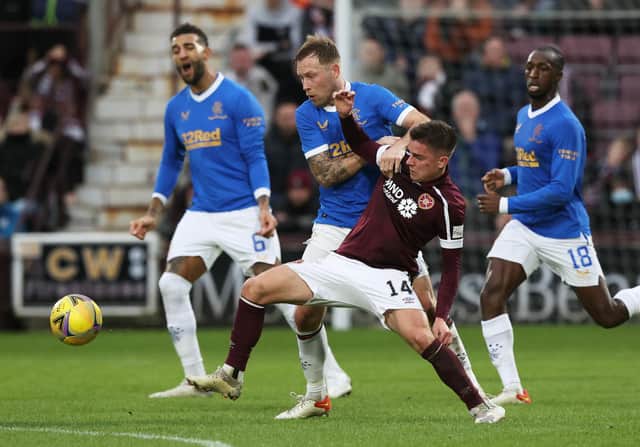 Scott Arfield challenges Hearts' Cammy Devlin during Rangers' 2-0 win at Tynecastle. Picture: SNS