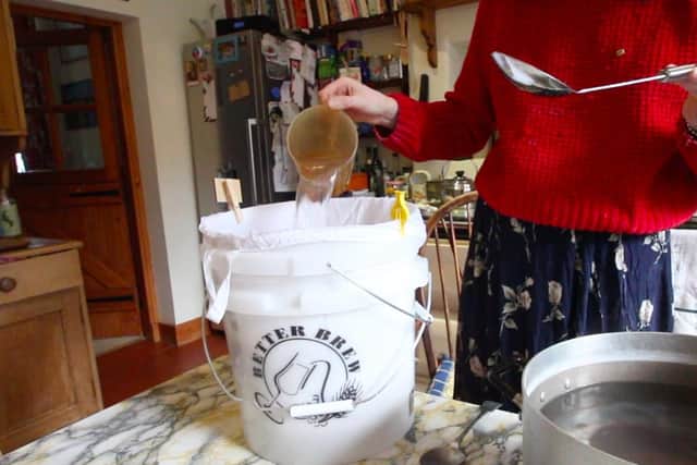 Gradually add the boiling water to your muslin bag of grain using a jug. I have been using a 1 to 2.5 grain to water ratio.