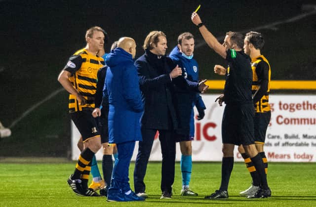 Hearts manager Robbie Neilson (left) and Andy Halliday confront the referee Gavin Duncan at full time at Alloa.