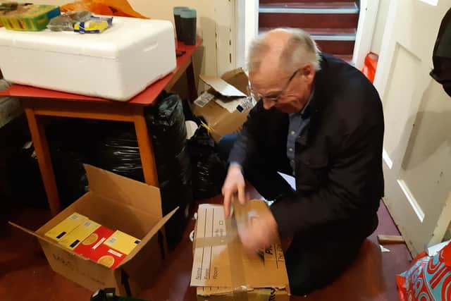 Terry Kowal packs a box ready to be sent to refugees in Ukraine.