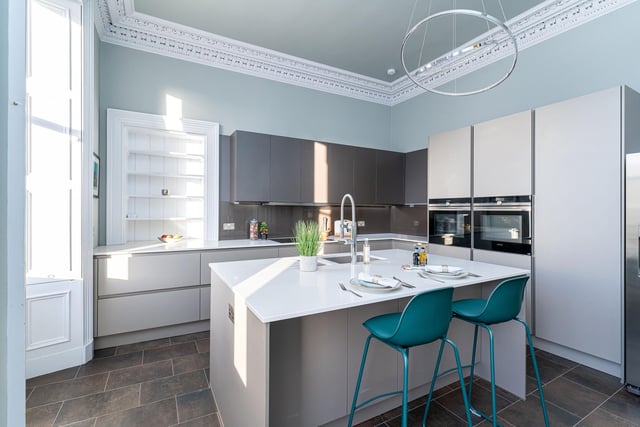 The property includes this spectacular designer kitchen with island/breakfast bar, stylish sleek handleless cabinetry and integrated appliances including double Siemens oven and Miele dishwasher.