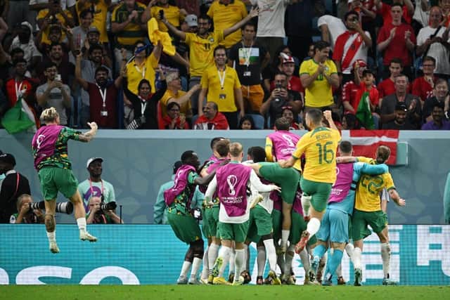 The Australia squad rush to celebrate after Mathew Leckie puts the Socceroos 1-0 up against Denmark in the final World Cup group-stage encounter. Picture: Getty