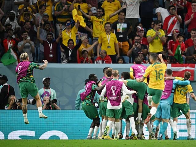 The Australia squad rush to celebrate after Mathew Leckie puts the Socceroos 1-0 up against Denmark in the final World Cup group-stage encounter. Picture: Getty