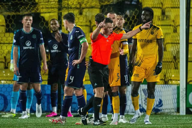 Ref Grant Irvine is called over for a contentious VAR review - but reached the right decision in the end.