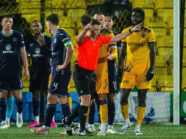 Ref Grant Irvine is called over for a contentious VAR review - but reached the right decision in the end.
