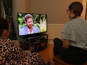 A family gather around the television in Liverpool to watch Prince Harry and his wife Meghan's explosive tell-all interview with Oprah Winfrey in March (Photo: PAUL ELLIS/AFP via Getty Images)