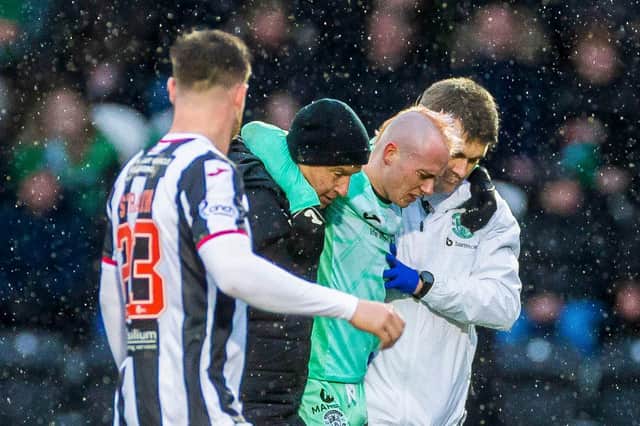 Hibs forward Harry McKirdy is helped off the pitch after just 17 minutes. Picture: Roddy Scott / SNS