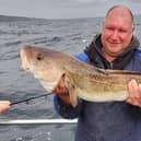 Dean Thompson proudly holding a 12lb 2oz cod, the best landed for 12 years on an Aquamarine Charters boat out of Eyemouth. Picture: Aquamarine Charters