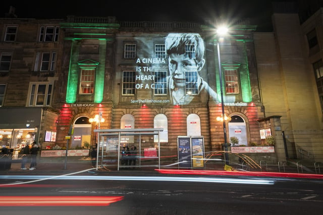 An image from the classic Bill Douglas film My Childhood, projected onto the Filmhouse in Edinburgh, is one of several movie images projected onto landmarks and public buildings in the city as part of the campaign to save the Edinburgh International Film Festival and the Filmhouse.