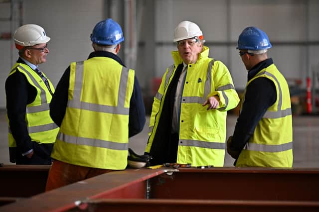 Boris Johnson speaks with staff members during a visit to Rosyth Shipyard yesterday (Picture: Jeff J Mitchell/pool/AFP via Getty Images)