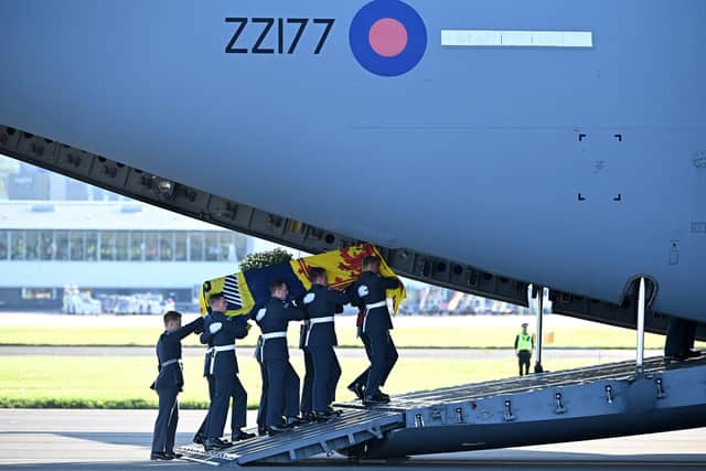 Pallbearers from the Queen's Colour Squadron of the Royal Air Force (RAF) carry the coffin of Queen Elizabeth II, draped in the Royal Standard of Scotland, into a RAF C17 aircraft at Edinburgh Airport.