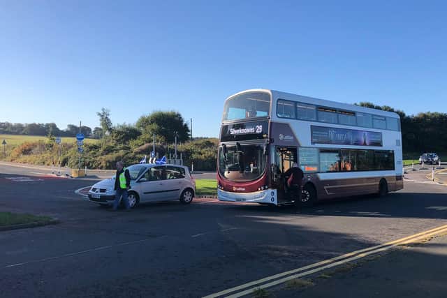 Mr Scotland uses his car to block the roundabout at Marine Drive where the bus wants to turn