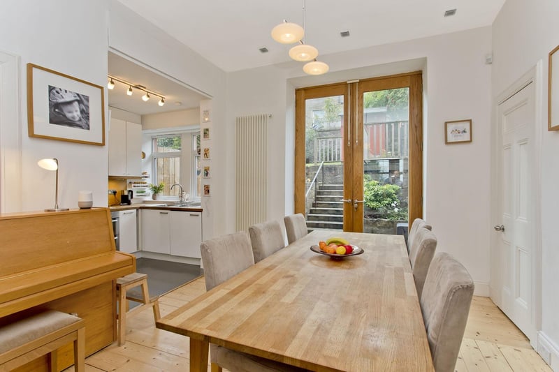 The dining room incorporates built-in storage and can comfortably accommodate a large table and additional furniture.