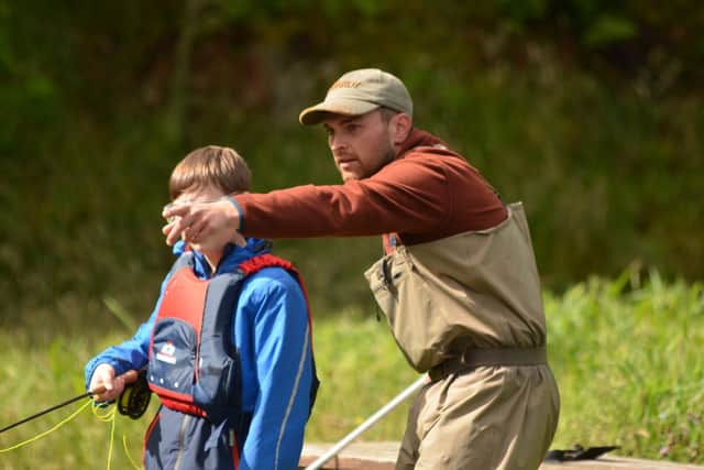 Connor Newcombe giving a young angler instruction at Kailzie