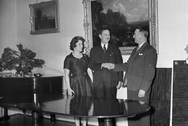 Lord and Lady Dalrymple receive a dining table from their tenants at a party at Oxenford Castle, in Dalkeith, in March 1960.