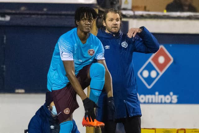 Armand Gnanduillet prepares to come on for his Hearts debut.